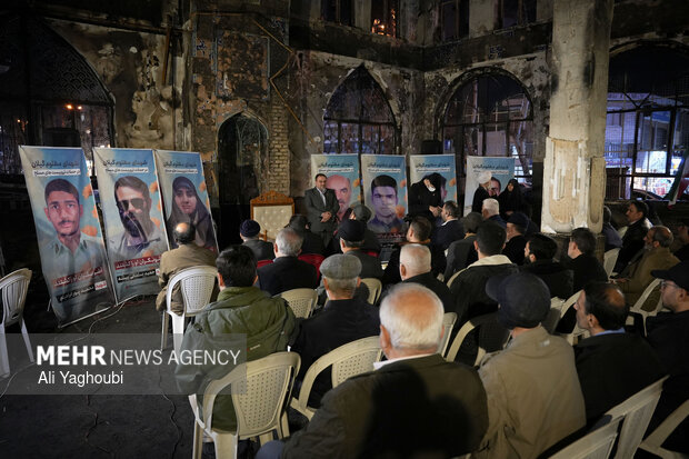 Performing prayers at burnt Hojjatieh Mosque in Rasht
