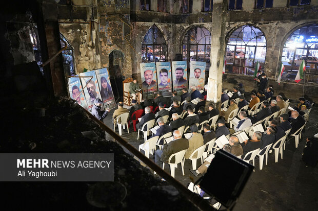 Performing prayers at burnt Hojjatieh Mosque in Rasht
