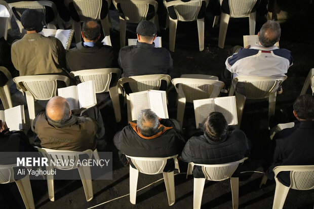 Performing prayers at burnt Hojjatieh Mosque in Rasht
