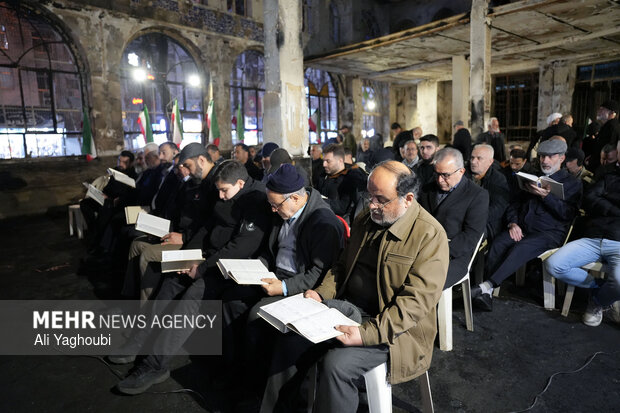 Performing prayers at burnt Hojjatieh Mosque in Rasht
