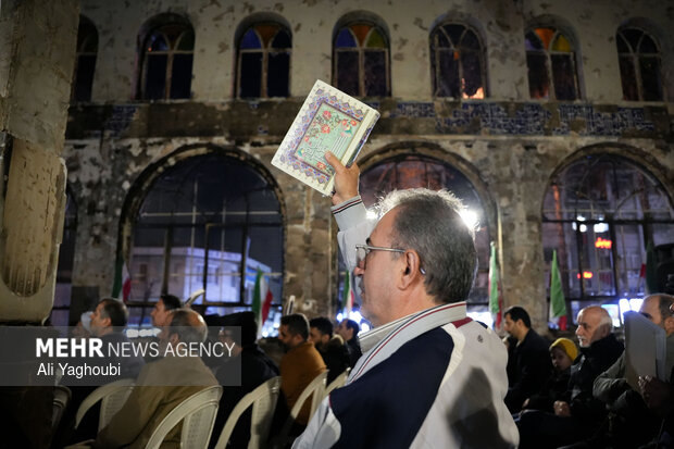 Performing prayers at burnt Hojjatieh Mosque in Rasht
