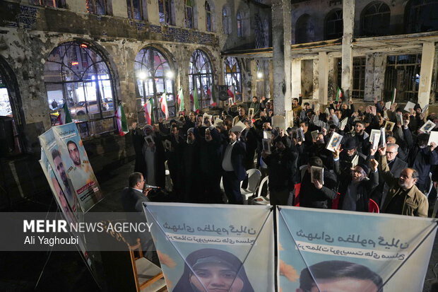 Performing prayers at burnt Hojjatieh Mosque in Rasht
