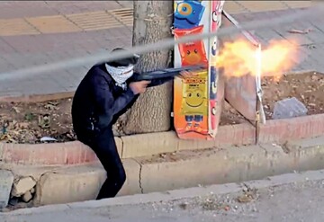 The photo shows an armed rioter shooting at peaceful protesters in the city of Lordegan, Chaharmahal-Bakhtiari province.