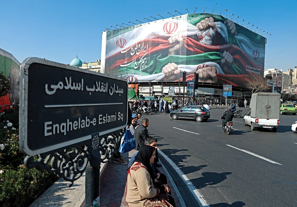 A mural on Tehran’s Enghelab Street, pictured on January 12, 2026, reads: “Iran is our homeland, the national flag is our shroud.”