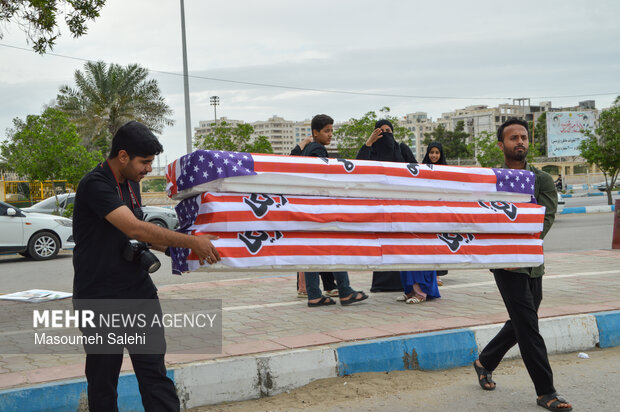 تشکیل زنجیره انسانی و آتش زدن نمادین تابوت سربازان آمریکایی در ساحل خلیج فارس