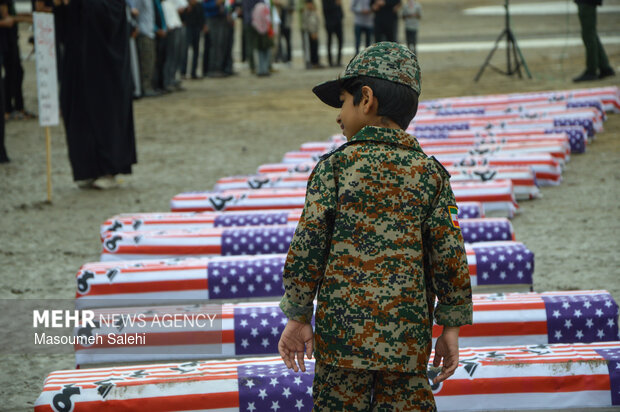 تشکیل زنجیره انسانی و آتش زدن نمادین تابوت سربازان آمریکایی در ساحل خلیج فارس