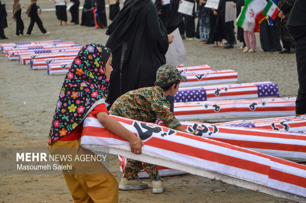 تشکیل زنجیره انسانی و آتش زدن نمادین تابوت سربازان آمریکایی در ساحل خلیج فارس