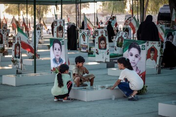 Family members gather at the burial site of students killed in a U.S. attack on a girls school in Minab