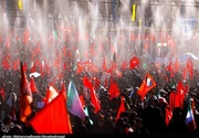 Mourners fly red flags, calling for avenging Leader's blood